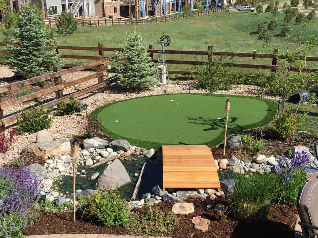 Overview of bridge crossing dry river over to putting green.